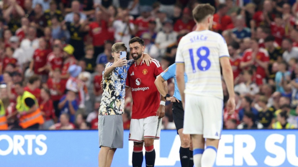 Pitch invaders take selfies with Fernandes during Man Utd friendly